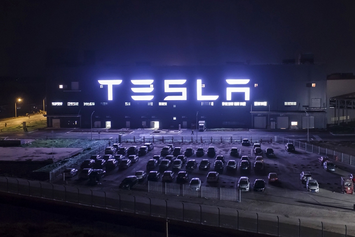 Tesla’s Gigafactory illuminates the night in Shanghai. Photo: Bloomberg