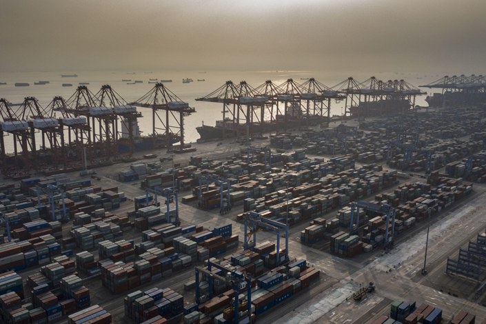 Shipping containers are stacked near gantry cranes at the Port of Nansha in Guangzhou on Nov. 20, 2020.  Photo: Bloomberg