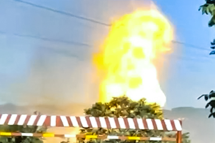 A fire rising meters high can be seen billowing from the vicinity of the pipeline in videos obtained and verified by Caixin.