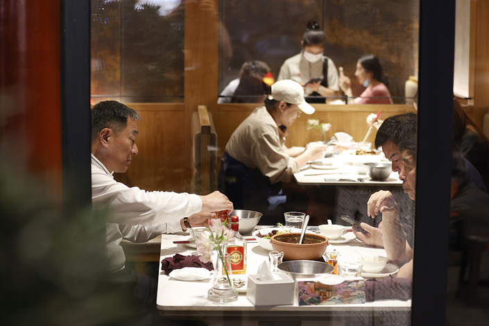 People dine in a restaurant on Monday in Beijing. Photo: VCG