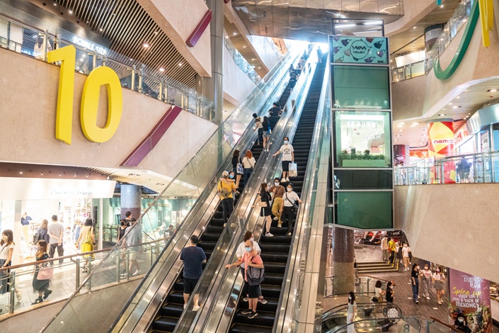 Visitors ride escalators inside a shopping mall in Hong Kong’s Mong Kok district on April 30. Photo: Bloomberg