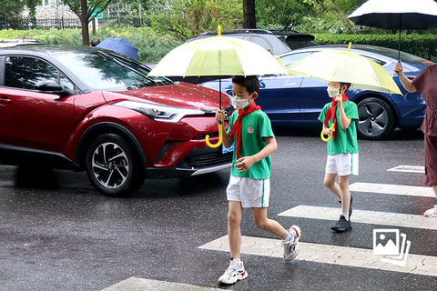 2022年6月27日，北京市，人大附小学生雨中返校。按照北京市疫情防控工作领导小组部署，6月27日，北京市小学一至六年级、初一初二和高一高二年级的学生结束了近两个月的居家学习，正式返校上课。仍处于封控区、管控区和居家隔离的学生则继续居家学习。图：人民视觉