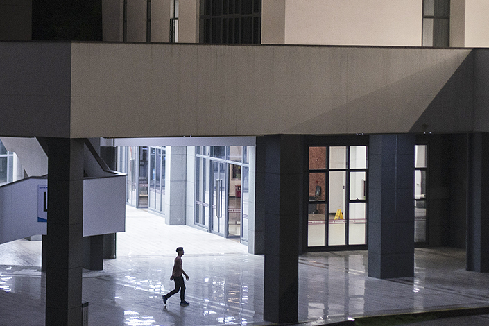 A man walks through an office area in Shenzhen at night Photo: VCG