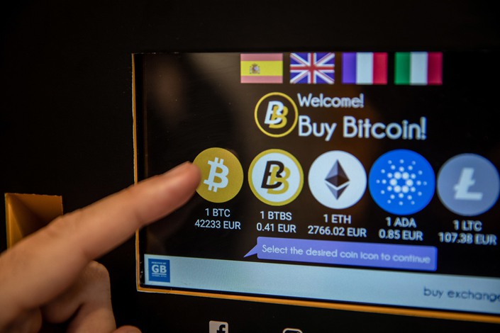 A customer selects Bitcoin for purchase on the screen of a cryptocurrency ATM in Barcelona, Spain, on March 9. Photo: Bloomberg