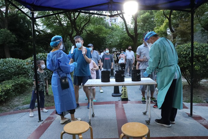 Residents get tested for Covid-19 at a residential complex in Shanghai on Tuesday. Photo: VCG