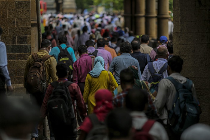 Commuters exit the Chhatrapati Shivaji Maharaj Terminus railway station in Mumbai on July 6, 2020. Photo: Bloomberg