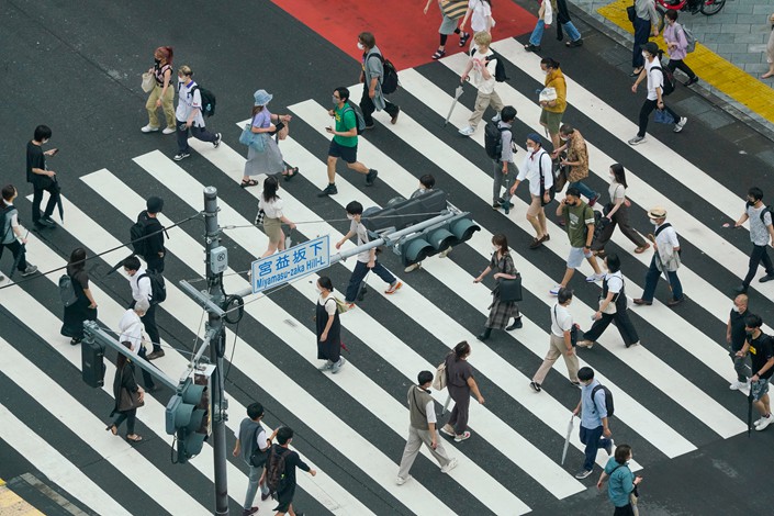 Pedestrians cross an intersection in Tokyo, Japan, on July 13. Photo: VCG