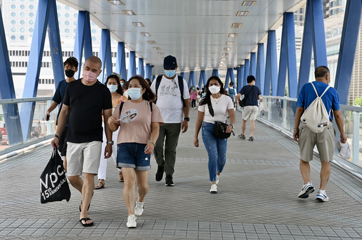 Masked pedestrians in Hong Kong. The city is facing a muted resurgence of Covid-19, slowed by a hybrid immunity that has developed in the local population, according to experts. Photo: VCG