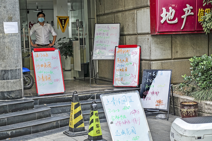 Pre-owned homes displayed for sale at a real estate office in Shanghai June 16, 2022.