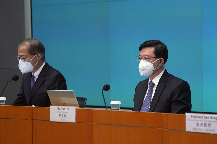 Hong Kong Chief Executive John Lee and the city’s health secretary, Lo Chung-Mau, appear at a news conference Monday in Hong Kong. Photo: VCG