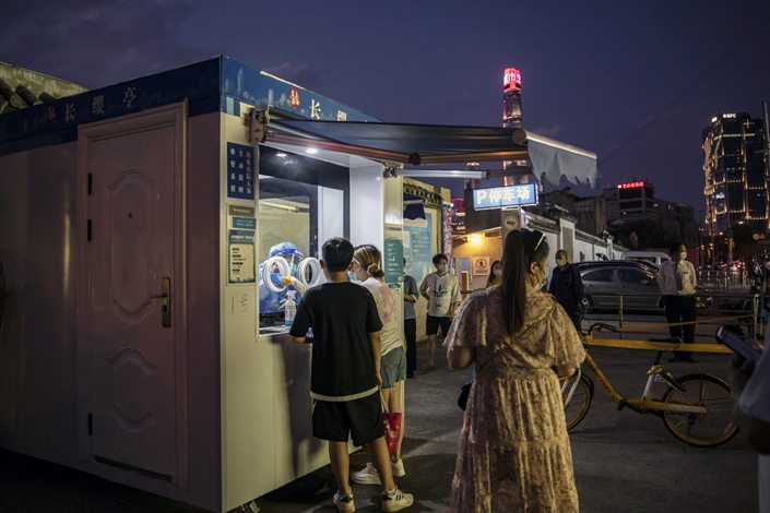 Residents queue at a Covid-19 testing booth in Shanghai on July 23. Photo: Bloomberg