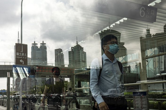 Pedestrians walk through Shanghai’s financial district of Lujiazui on June 20. Photo: Bloomberg