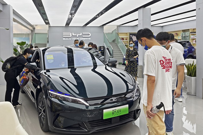 Customers check out a new-energy vehicle at a BYD dealership in Beijing on July 30. Photo: VCG