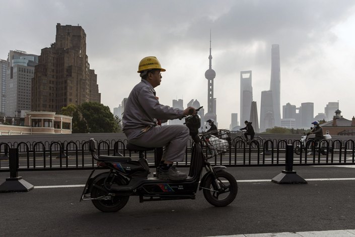 Motorists pass by Shanghai’s Lujiazui Financial District on Oct. 17. Photo: Bloomberg