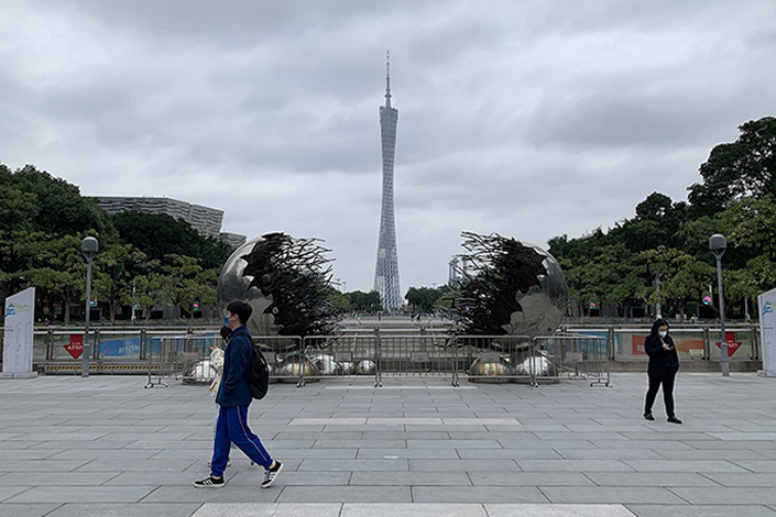 Citizens walk across a square with Guangzhou’s Canton Tower in the distance on Thursday. Photo: VCG