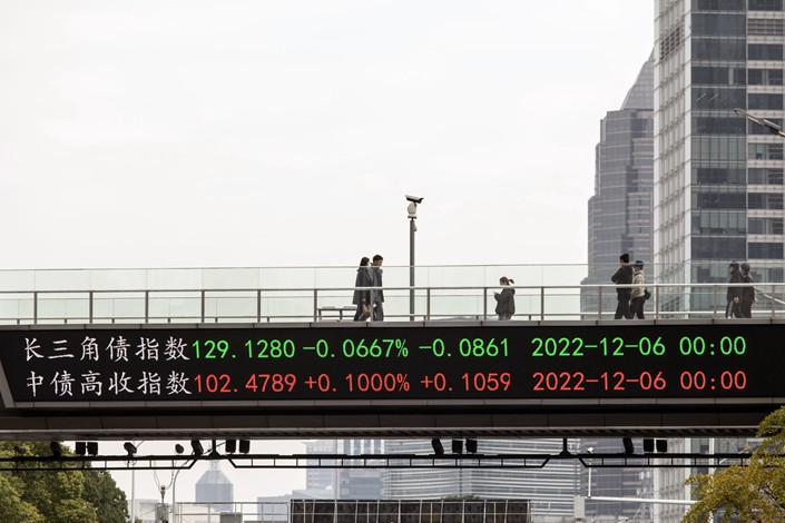 An electronic ticker displays stock figures on an elevated walkway in Pudong's Lujiazui Financial District in Shanghai on Dec. 7. Photo: Bloomberg