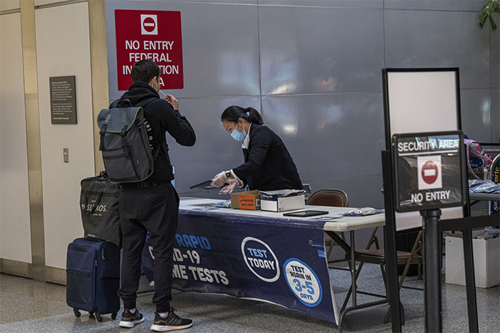 A traveler takes a self-administered Covid-19 test inside the arrivals hall of the international terminal at San Francisco International Airport in San Francisco on June 13. Photo: Bloomberg
