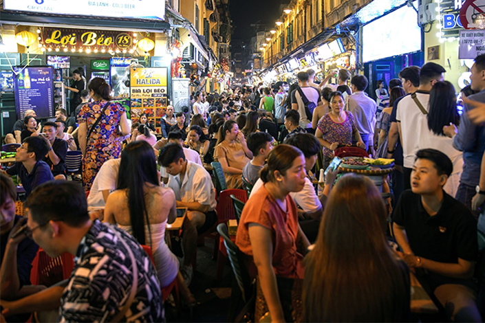 People dine on Ta Hien Street in Hanoi on June 11. Photo: Bloomberg