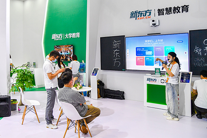 The booth of tutoring provider New Oriental Education & Technology Group at a trade fair in Beijing on Sept. 1. Photo: VCG
