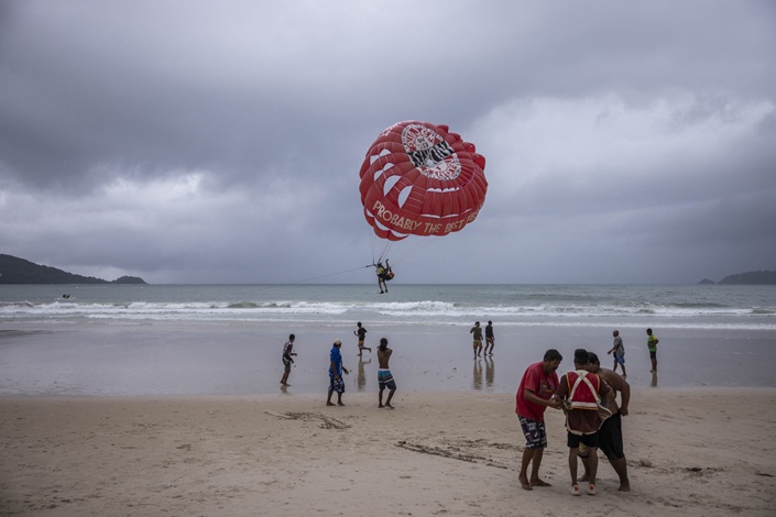 A parasailer takes off from Patong Beach in Phuket. Photo: Bloomberg