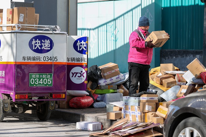 A deliveryman examines an express package in Beijing on Jan. 24. Photo: VCG