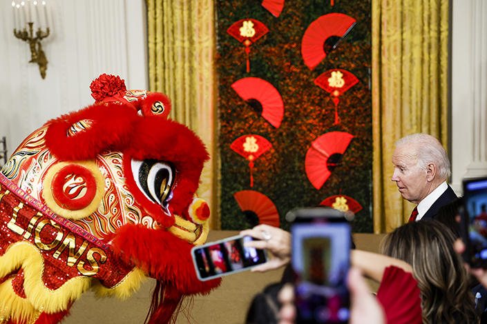 U.S. President Joe Biden looks on as members of the Choy Wun Lion Dance Troupe perform at a reception celebrating the Lunar New Year in the East Room of the White House in Washington on Jan. 26. Photo: Anna Moneymaker/VCG