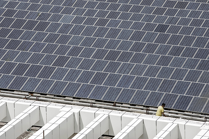 A worker walks past a rooftop solar farm in September 2017 at automaker BYD’s headquarters in Shenzhen, South China’s Guangdong province. Photo: Bloomberg