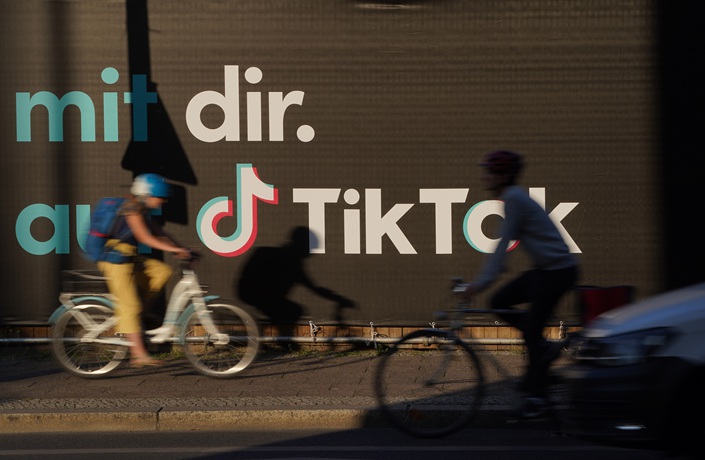 Bicyclists ride past an advertisement of social media company TikTok on Sept. 21, 2020 in Berlin. Photo: VCG