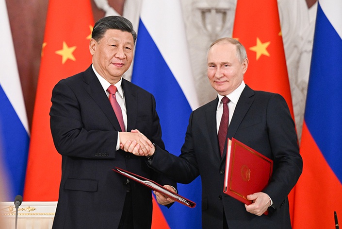 President Xi Jinping and Russian President Vladimir Putin shake hands after signing documents on strategic and economic cooperation on Tuesday in Moscow. Photo: Xie Huanchi/Xinhua