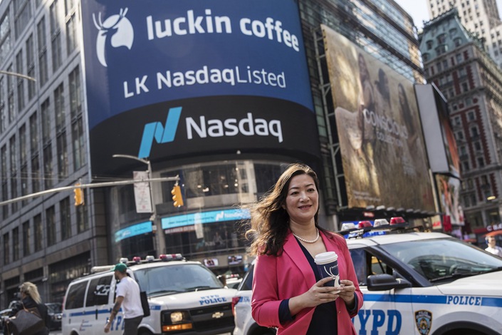 Jenny Qian, then Luckin Coffee’s CEO, stands outside the Nasdaq during the company’s IPO in 2019. Photo: Bloomberg