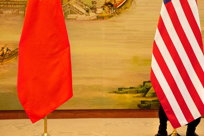 Flags on display at a news conference between Foreign Minister Wang Yi and U.S. Secretary of State John Kerry at the Ministry of Foreign Affairs in Beijing on Jan. 27.  Photo: Bloomberg