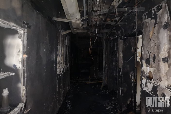 Walls of a fifth-floor corridor are severly damaged and covered in soot after a severe fire broke out in the inpatient department of Beijing Changfeng Hospital. Photo: Zhang Ruixue/Caixin