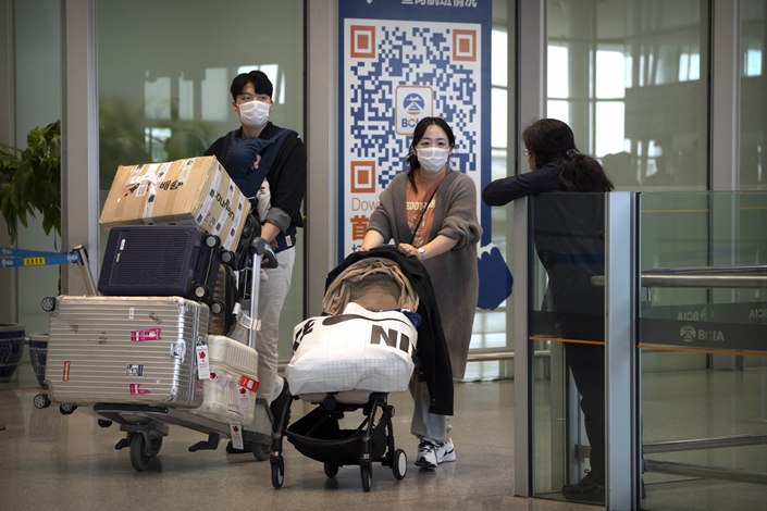 Travelers walk through Beijing Capital International Airport on Wednesday. Photo: VCG