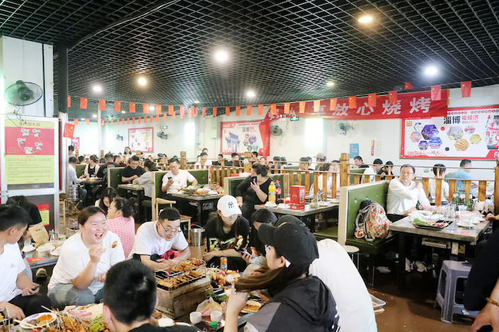 A barbecue restaurant packed with customers in Zibo, Shandong province, May 2, 2023.