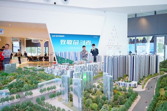 Customers view houses at a sales office in Huizhou, Guangdong province, on March 26, 2023.