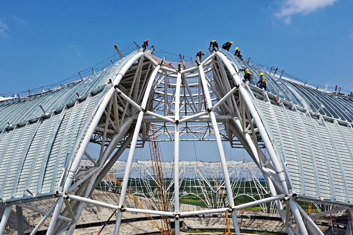 Workers are building a new stadium in Xuchang, Henan province, on April 25, 2023.