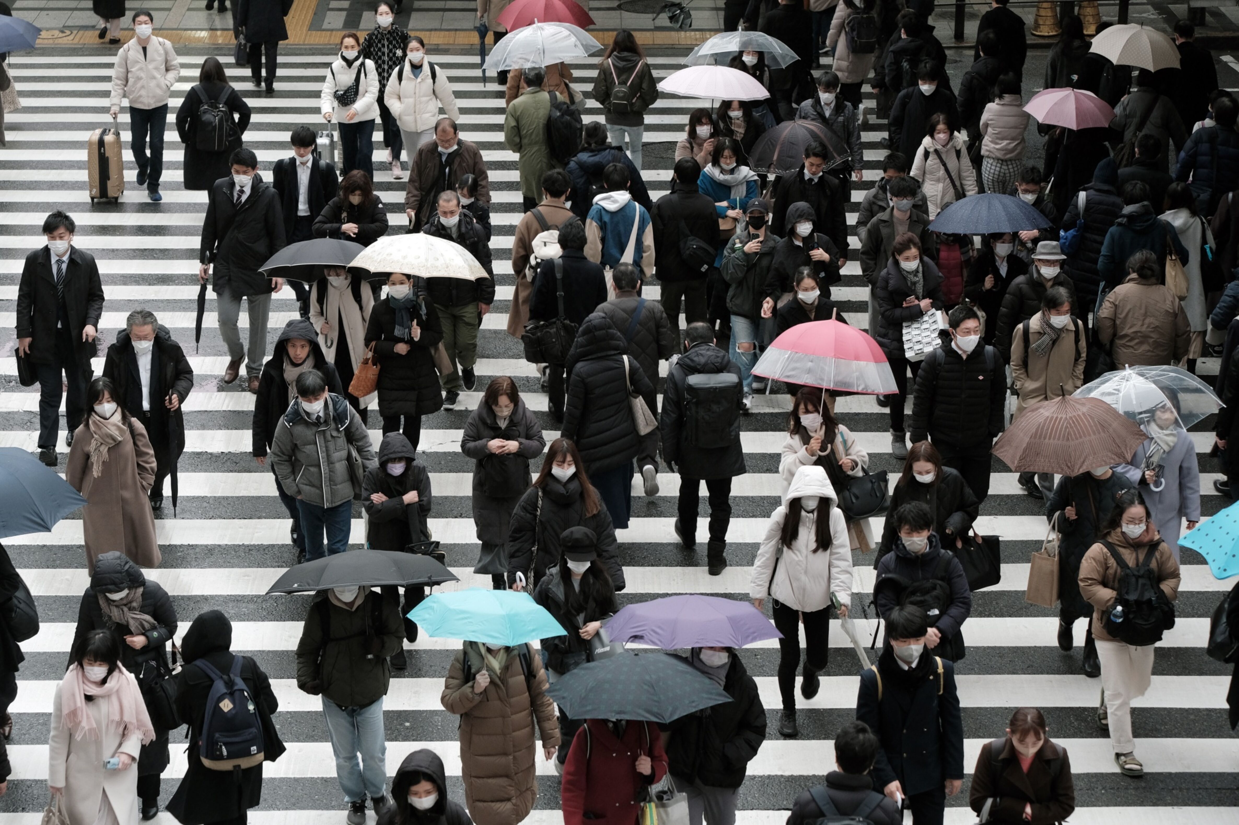Pedestrians cross a road on Feb. 13 in Osaka, Japan. Photo: Bloomberg