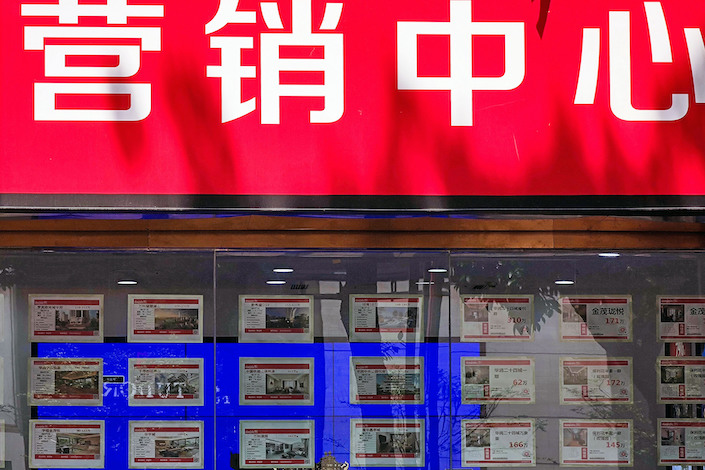 Pre-owned homes displayed for sale at a real estate office in Chongqing on May 16, 2023.
