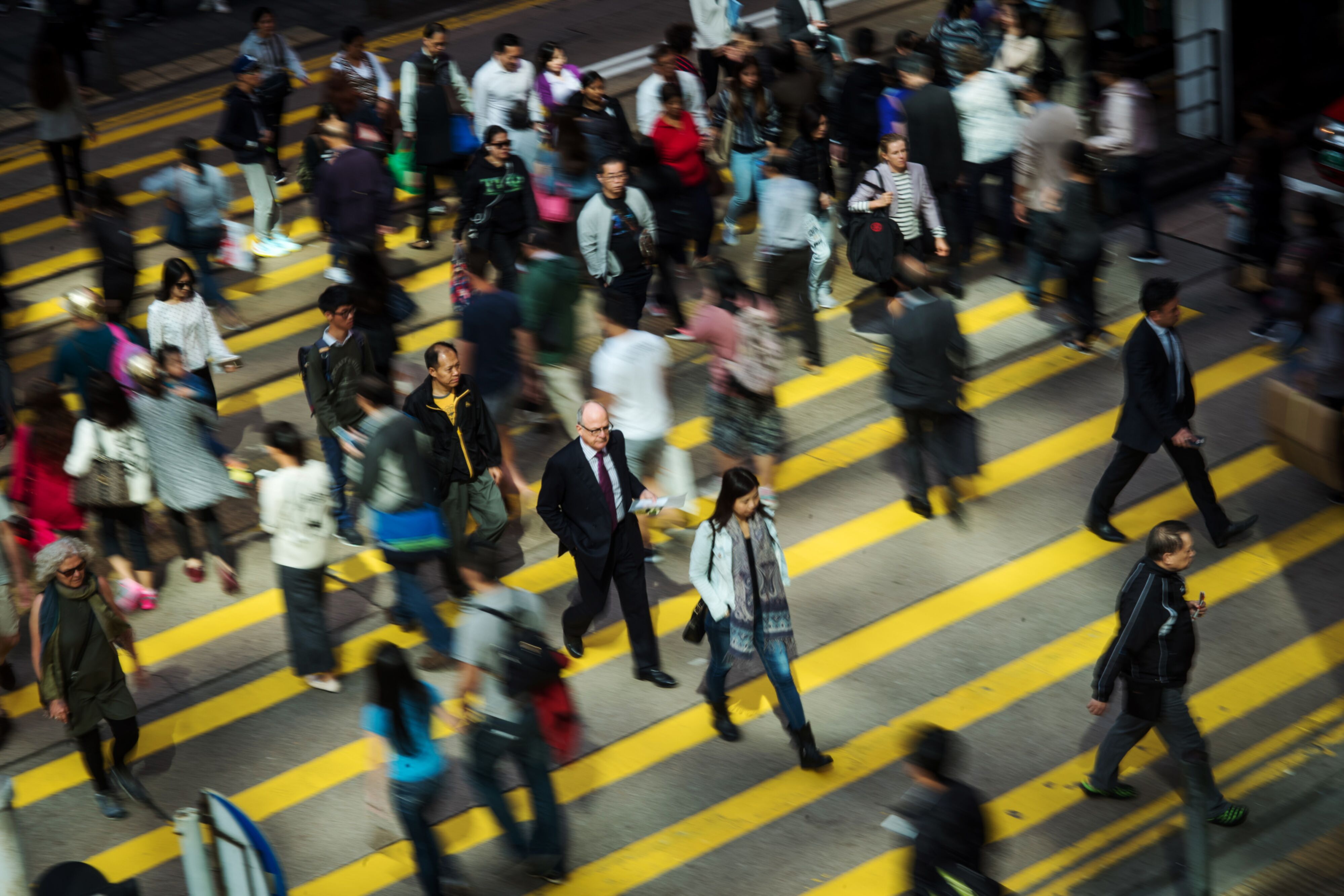 Pedestrians cross a road in Hong Kong’s Central district in November 2017. Photo: Bloomberg