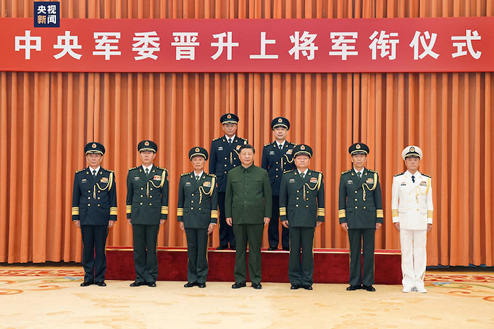 Xi Jinping, chairman of the Central Military Commission, Monday presented certificates of order to promote the commander of the Rocket Force Wang Houbin and its political commissar Xu Xisheng to the rank of general. Photo: Xinhua