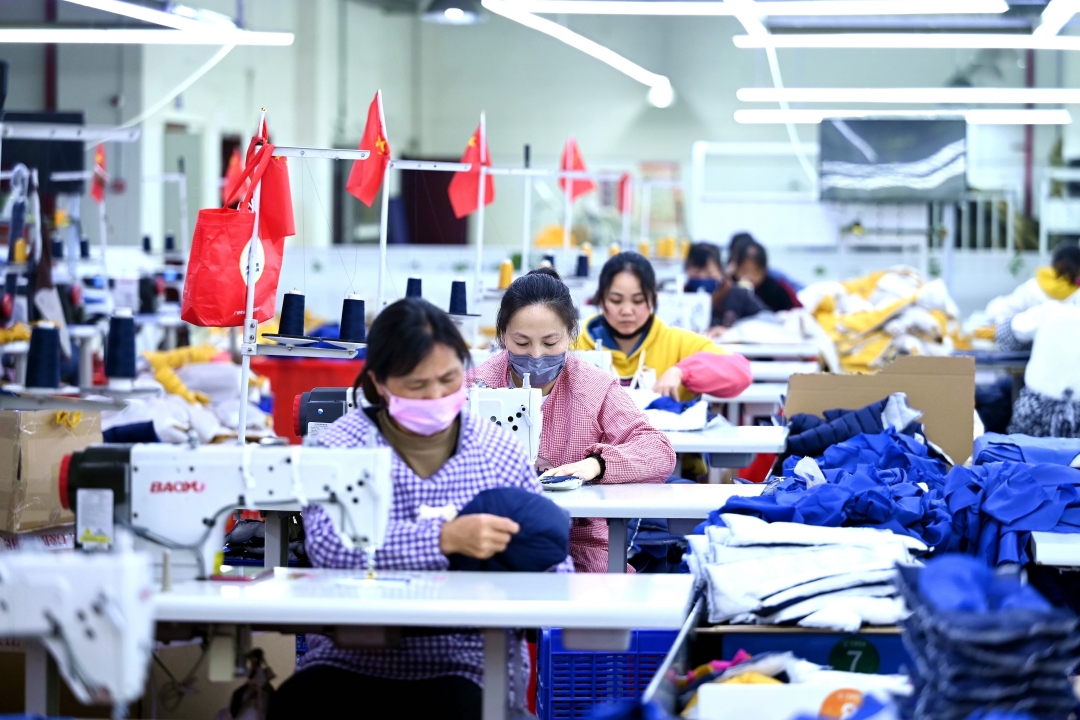 Workers sew garments in Southwest China’s Guizhou province on April 11. Photo: VCG