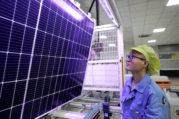 A worker is making PV modules at a factory of Jiangsu Xinyuan Solar Technology Co. Ltd. in Huaian, Jiangsu Province, on Sept. 5, 2023