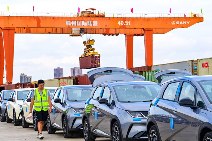 A port employee inspects new-energy vehicles set for export on Sept. 13 in Ganzhou, East China’s Jiangxi province. Photo: IC Photo