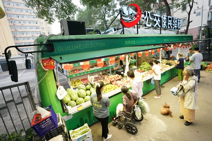 Customers buy vegetables in Beijing on Sept. 8. Photo: VCG