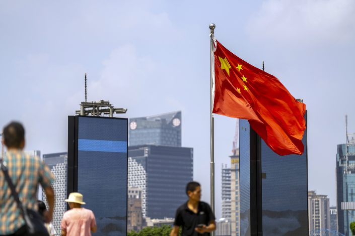 A Chinese flag flies over Shanghai’s financial district on Monday. Photo: Bloomberg