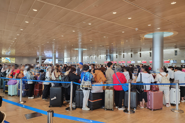 Passengers in line at Tel Aviv’s Ben Gurion International Airport on Oct. 10, 2023.