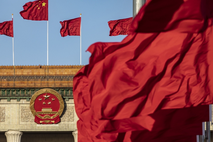 China’s national flag flies over Tiananmen Square in Beijing along with other red flags on March 12. Photo: Bloomberg