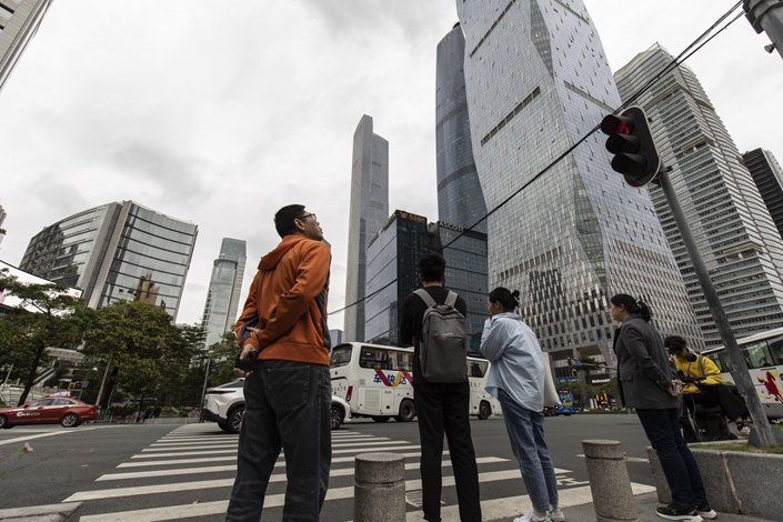 Pedestrians stand at a crosswalk on Nov. 16 in Guangzhou, South China’s Guangdong province. Photo: Bloomberg