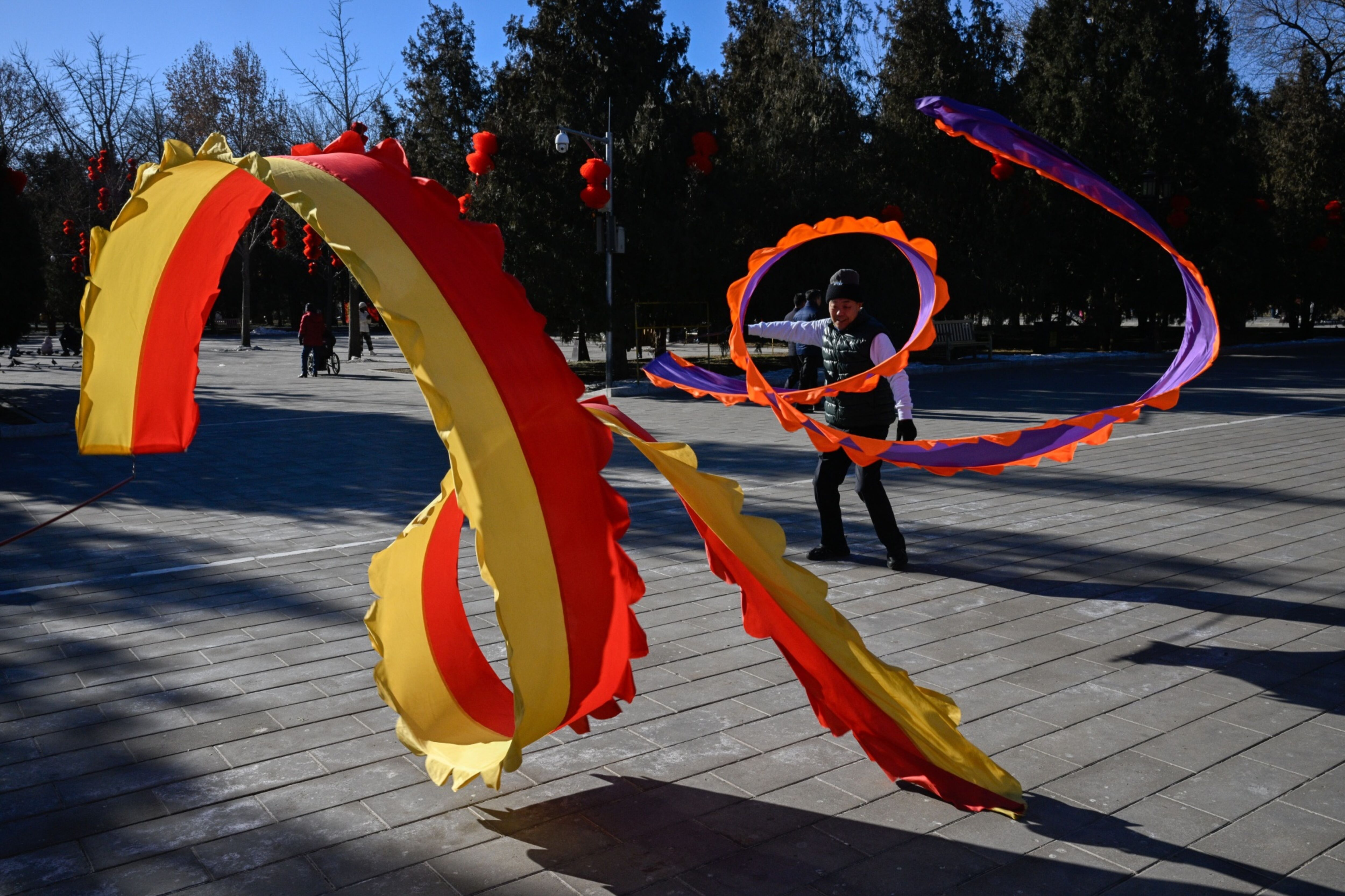 A person dances with a ribbon at a park in Beijing on Wednesday. Photo: Bloomberg