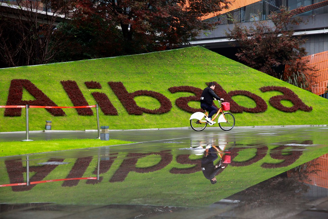 A cyclist passes Alibaba's headquarters in Hangzhou. Photo: VCG